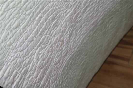 An off-white quilt with blue stitching, a reversible blue and cream quilt, a creamy oyster quilt and a mint green quilt (4)